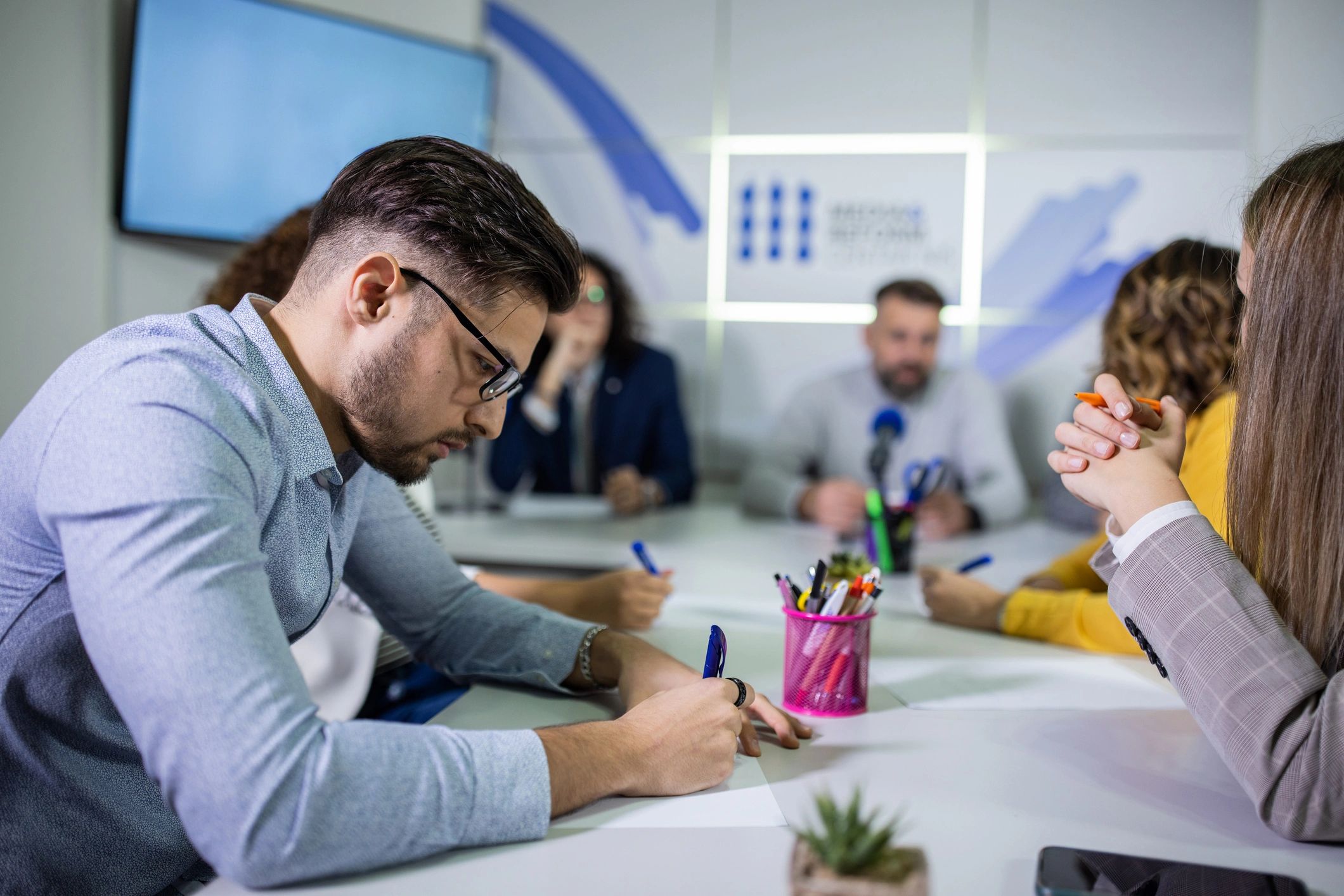 Reporter taking notes during a press conference