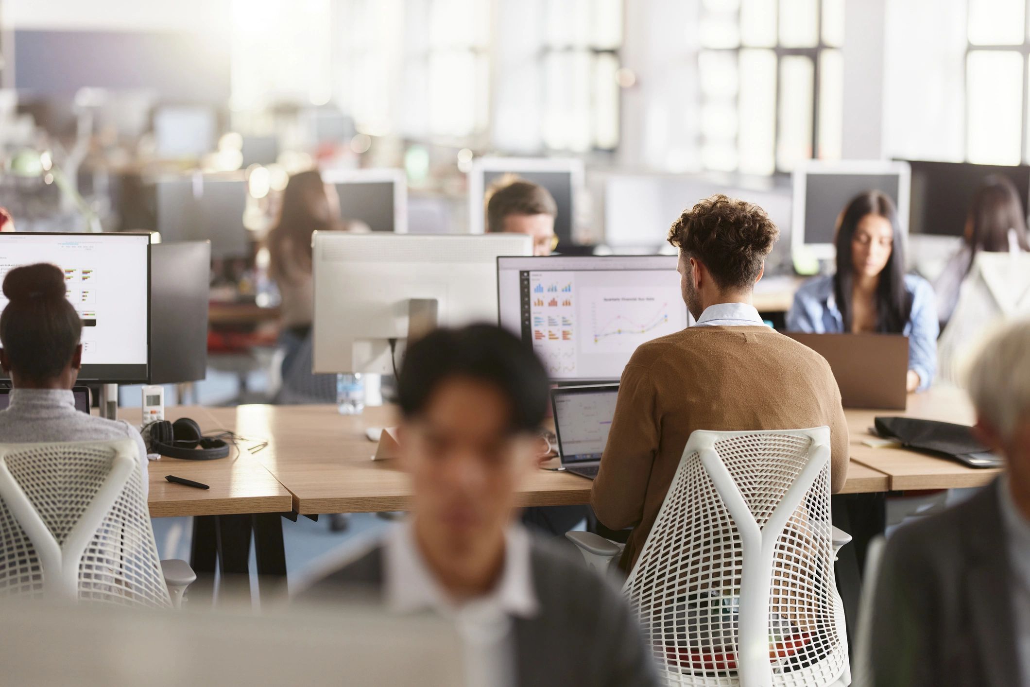 Journalists working at computers in a newsroom