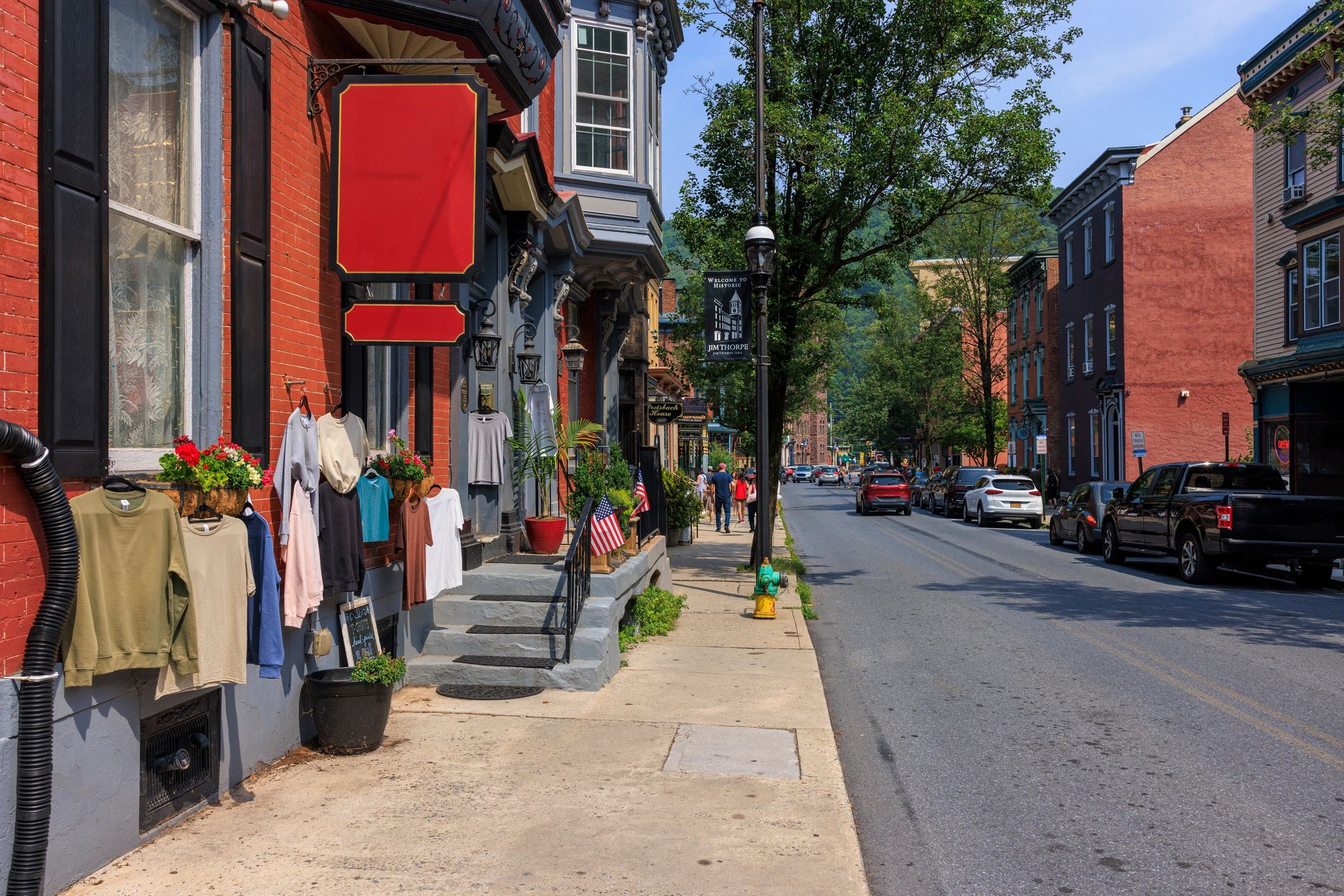 Small town main street storefronts with an American flag